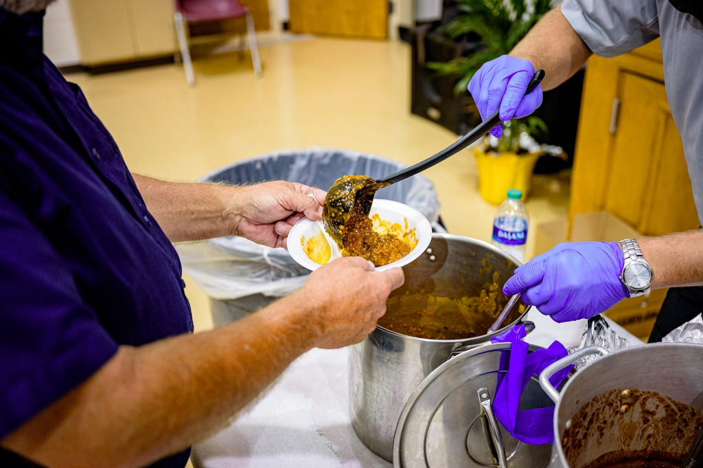 Volunteer serving a hot meal at a community kitchen